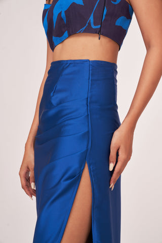Close-up of the gathered waistline and ruching details on the satin-finish skirt, emphasizing the high side slit construction.