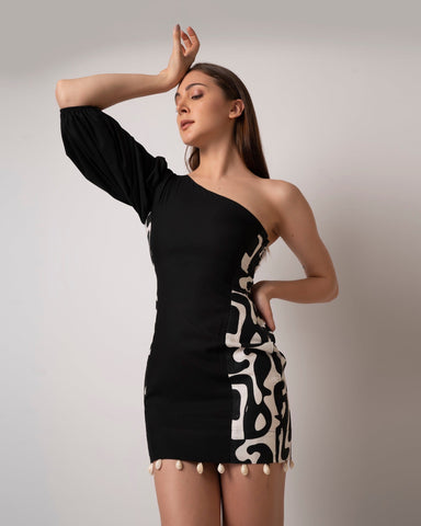 Black printed one-shoulder cotton mini dress with shell accents, ideal for beach vacations and seaside strolls