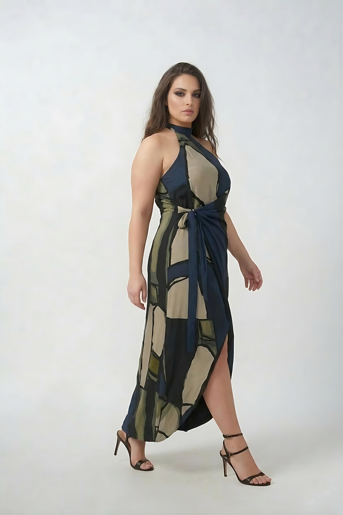 Curve fit crepe dress with a one-shoulder halter neckline and wrap style, designed to define the waist and flatter the shape