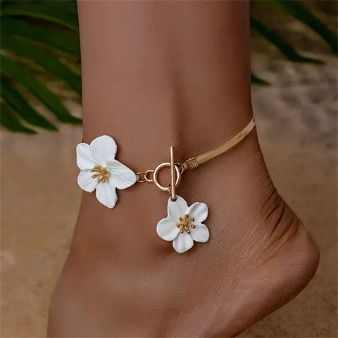 A delicate floral charm anklet that sits gracefully on the ankle, making it an ideal choice for a romantic date night or a breezy weekend brunch with friends.