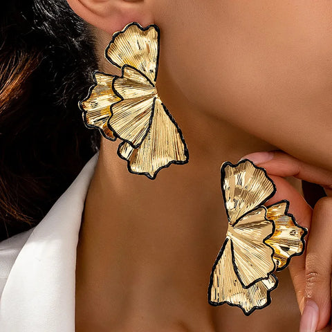 These artistic leaf petal gold-toned earrings sit snugly against the ear, offering a subtle botanical-inspired look that is perfect for a bridal shower, a garden party, or a chic day at the office.