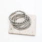 This versatile four-piece silver anklet set features a combination of minimalist chains and patterned beads, an ideal accessory for creating a curated, boho-chic look for summer festivals.