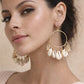 A woman modeling large imitation gold Shell Drop Earrings featuring a thin metallic hoop with multiple dangling white cowrie shells.