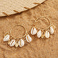 Imitation Gold Shell Drop Earrings featuring large circular hoops with multiple dangling white cowrie shells and gold charms