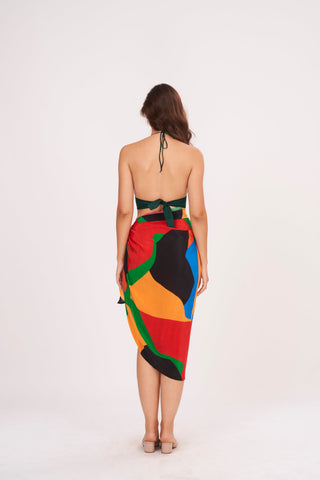 Rear view highlighting the tie-back detail of the crop top and the smooth drape of the sarong skirt. The Beach Sarong Wrap features a bold abstract pattern that stands out from every angle.